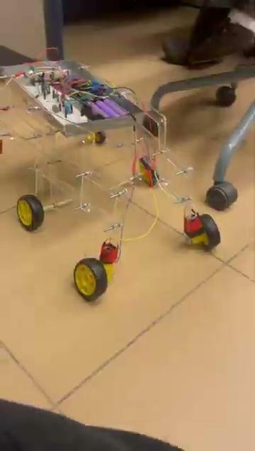 A top-down view of the prototype showcasing the modular chassis construction and integrated Arduino Mega control system for robust navigation.