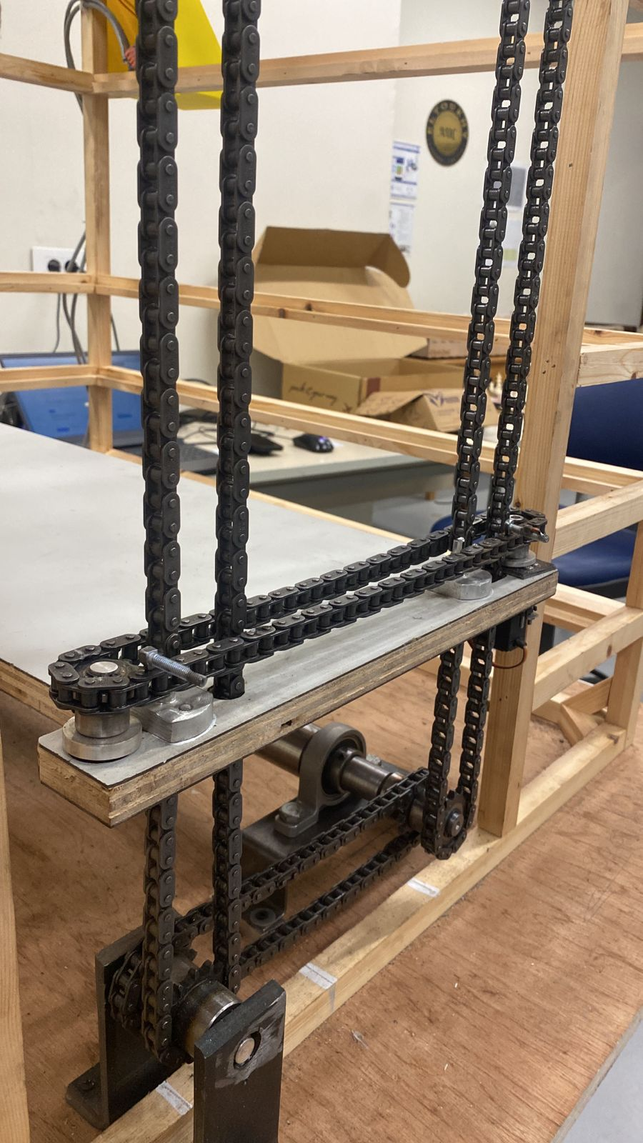 Close-up of the synchronized quad-chain drivetrain assembly.