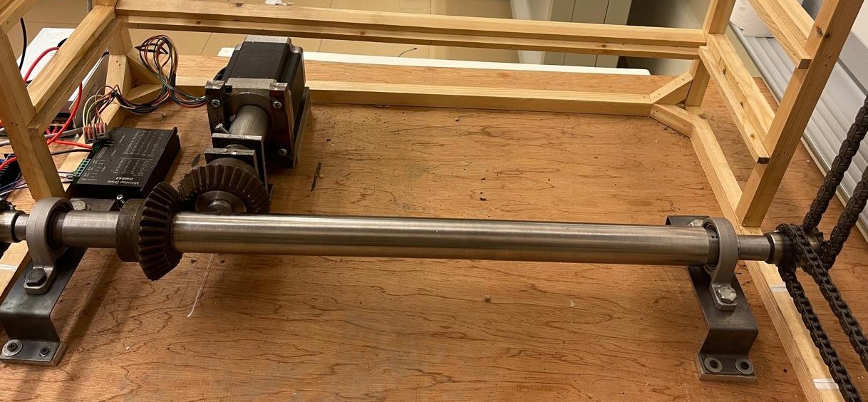 Steel ST37 shaft assembly coupled with the chain transmission network driven by the NEMA 34 stepper motor.